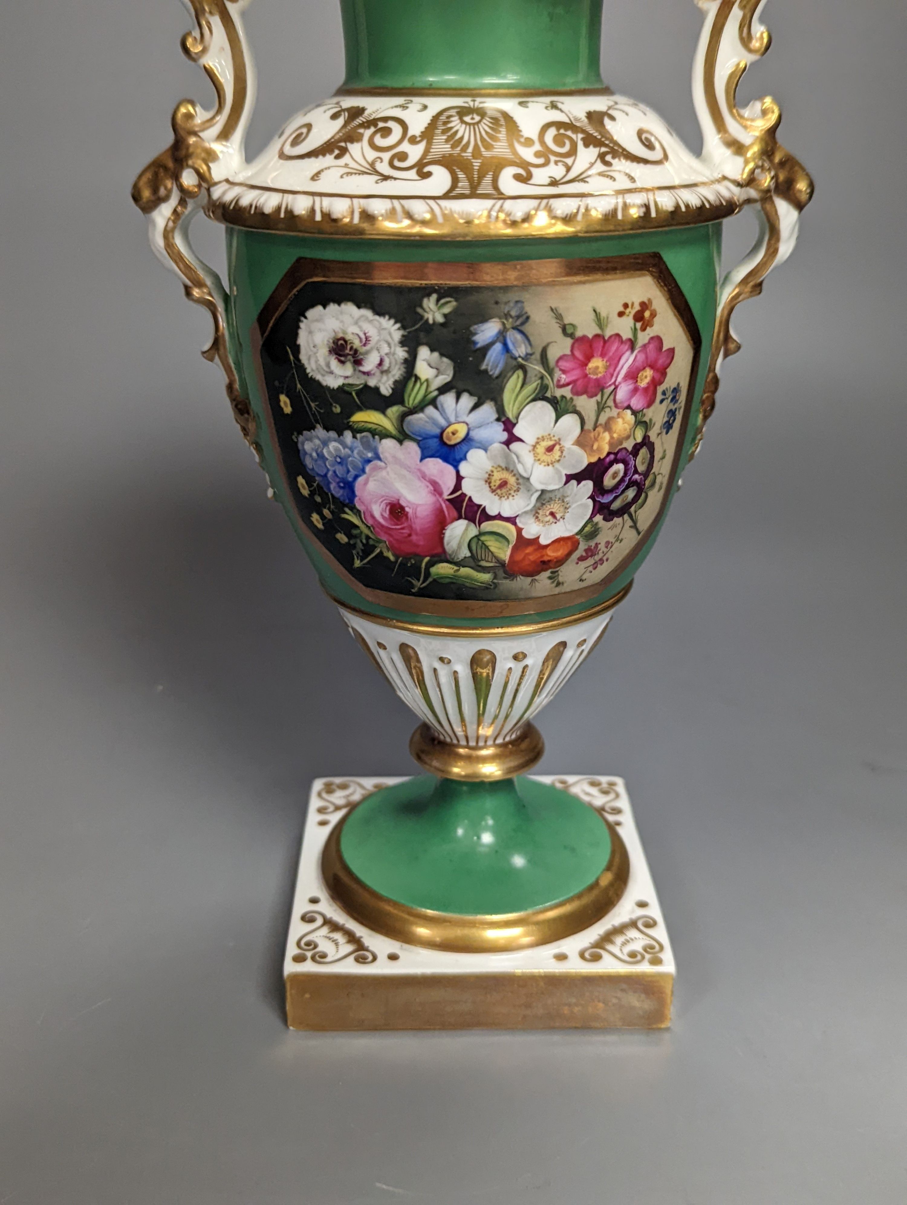 An English porcelain two handled vase painted with flowers in a panel on a green ground, probably Grainger Worcester, c.1830, height 24cm